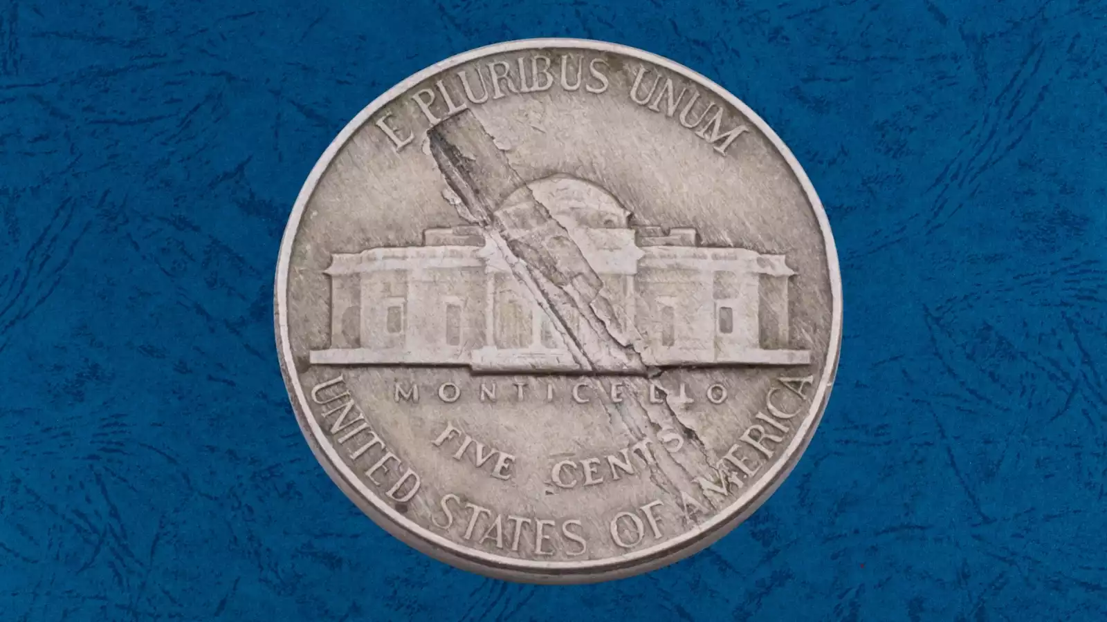 1948 nickel lamination error showing a section of metal peeling or flaking away from the coin surface revealing the underlying alloy layer